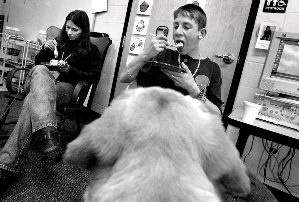 Award of Excellence, Feature Picture Story - Fred Squillante / The Columbus DispatchEven though Foreman got a special doggie treat earlier, he only could look on as Charlie Slane, right, and Walnut Springs Middle School teacher Amy DuBois, left,  eat their birthday cake during a celebration of the two-year anniversary of the Kids and Canines program.