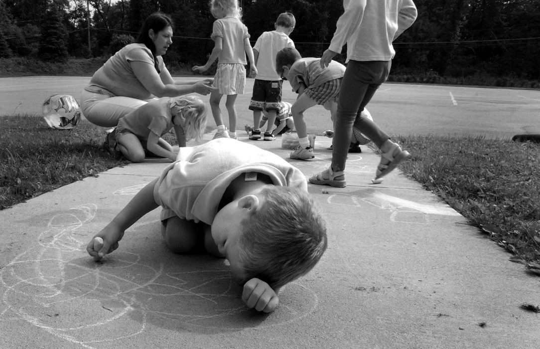 First Place, Feature Picture Story - Dale Omori / The Plain DealerMarcel draws on the sidewalk with chalk on his first day at Bainbridge Christian Preschool at Lord of Life Lutheran Church on his first day of regular preschool.  He didn't interact with the other children.