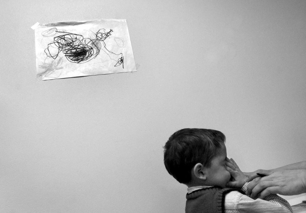 First Place, Feature Picture Story - Dale Omori / The Plain DealerTherapists at the Cleveland Clinic Center for Autism stop in mid-sentence if a child loses focus, and redirect attention.  Henri's therapist marks his every response on a data log.  The center uses the information to chart his progress.   Input Nov. 24, 2003. 