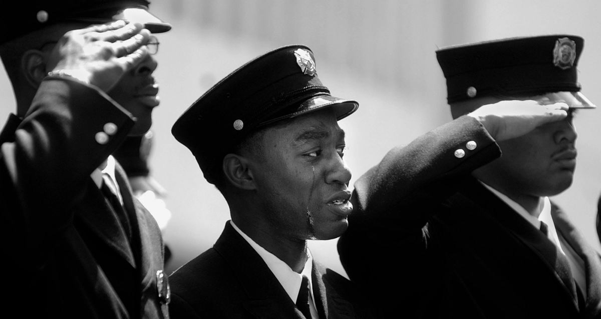 First Place, General News - Michael E. Keating / Cincinnati EnquirerTears stream down the face of a firefighter so overcome with emotion that he forgot to salute a fallen comrade during a burial service.  Oscar Armstrong III was killed in the line of duty when a flashover fire claimed his life and injured others.