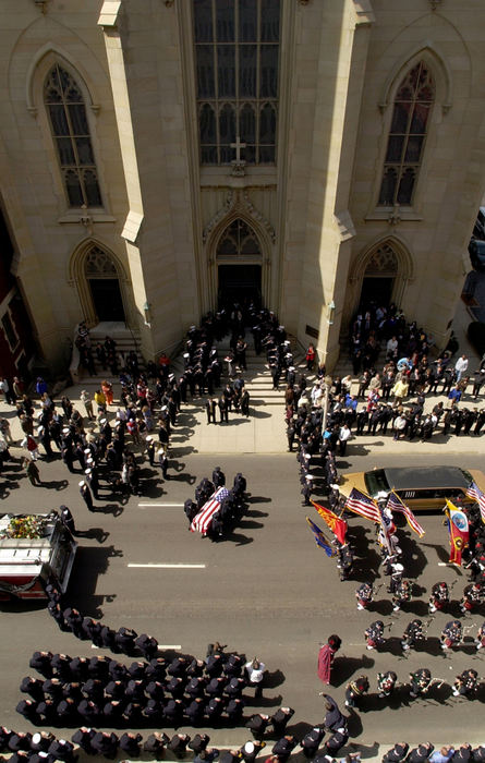 First Place, News Picture Story - Glenn Hartong / The Cincinnati EnquirerFirefighter Oscar Armstrong's casket is carried into St. Xavier Church in downtown Cincinnati