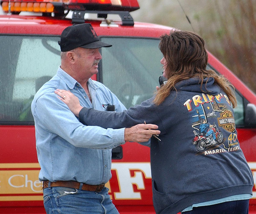 Second Place, News Picture Story - Carrie Cochran / Pulse-JournalDonald Haury's sister-in-law Pamela Short tells her father Jay Fisher that Haury, age 50 of Bellbrook, Ohio, was fatally shot Thursday morning at Watkins Motor Lines, Inc. on Centre Park Drive in West Chester Township. Tom West surrendered to police at a truck stop in Indiana hours later. The shooting left three wounded and two dead.