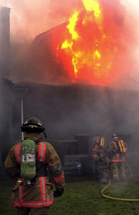 First Place, News Picture Story - Glenn Hartong / The Cincinnati EnquirerA Cincinnati firefighter watches as the Rapid Assistance Team (RAT Team) prepares to enter a burning house on the report of a firefighter down. A short search revealed that firefighter Oscar Armstrong had been caught in a flashover.  Armstrong was the first line of duty death in the department in more than 20 years. Hundreds of firefighters later attended his visitation and funeral.                          