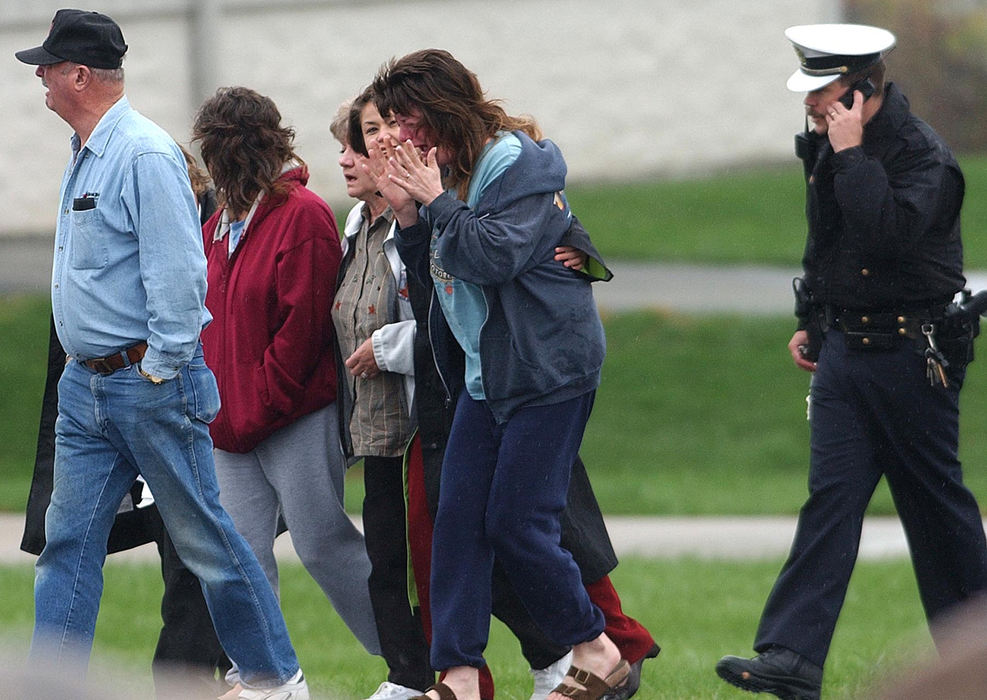 Second Place, News Picture Story - Carrie Cochran / Pulse-JournalPolice escort the famly of Donald Haury, age 50 of Bellbrook, Ohio, who was fatally shot Thursday morning at Watkins Motor Lines on Centre Park Drive in West Chester Township. 