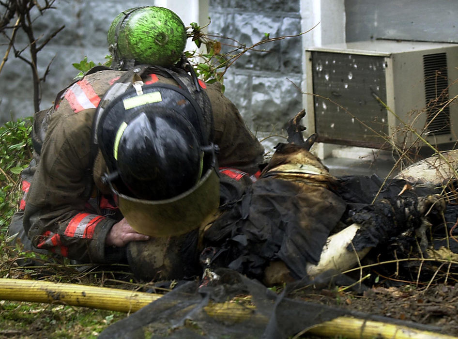 First Place, News Picture Story - Glenn Hartong / The Cincinnati EnquirerA Cincinnati firefighter, in a desperately futile effort, tries to give Oscar Armstrong mouth-to-mouth recussitation after Armstrong was caught in a flashover and then thrown outside by fellow firefighters who tried to rescue him. 