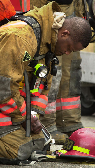 First Place, News Picture Story - Glenn Hartong / The Cincinnati EnquirerCincinnati firefighter Kevin Wyatt mourns at the scene after hearing that firefighter Oscar Armstrong had been officially pronounced dead.