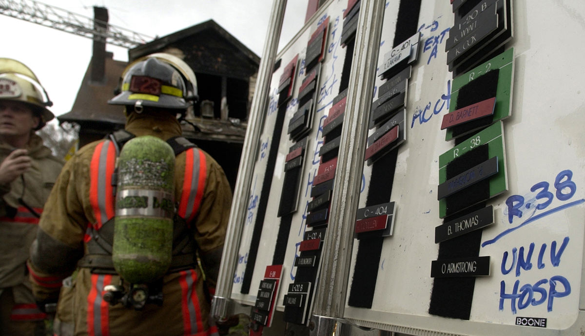 First Place, News Picture Story - Glenn Hartong / The Cincinnati EnquirerAt the scene of the house fire which resulted in his death Oscar Armstrong's accountability tag shows that he was taken to University Hospital. There he was officially pronounced dead.