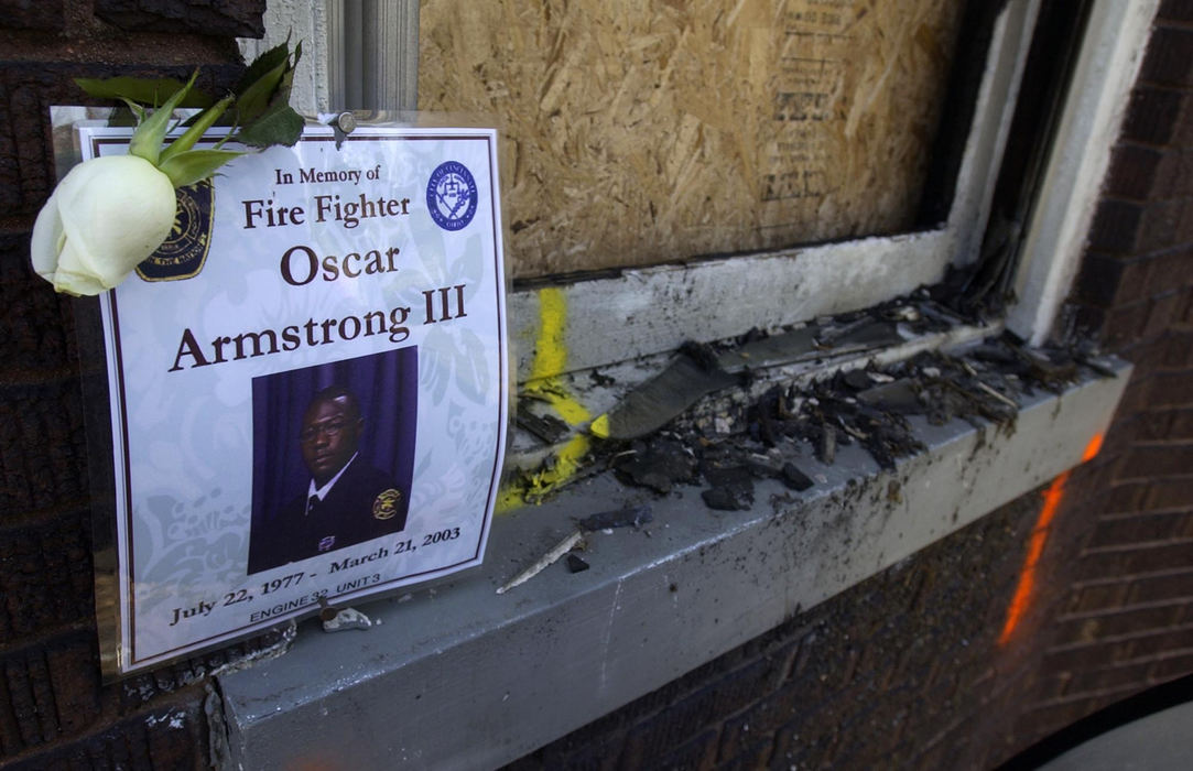 First Place, News Picture Story - Glenn Hartong / The Cincinnati EnquirerAt the house where he died a small sign and a flower mark the window through which Oscar Armstrong was thrown when fellow firefighters tried to rescue him. 