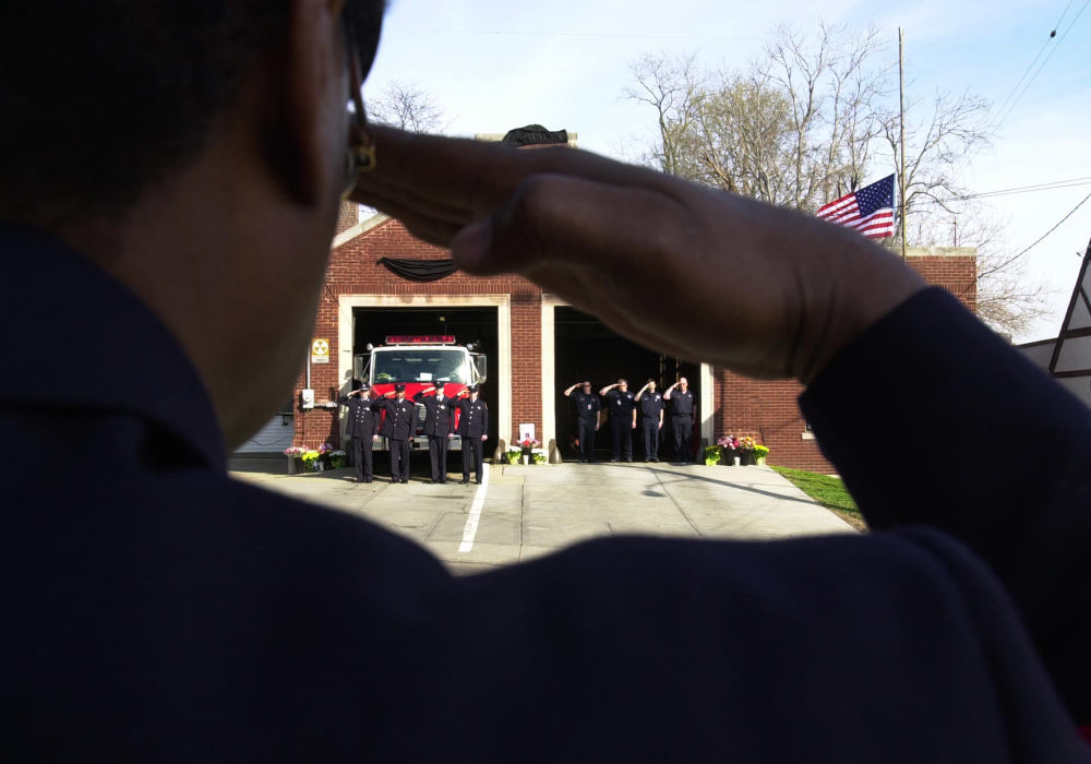 First Place, News Picture Story - Glenn Hartong / The Cincinnati EnquirerFirefighters from Columbus Ohio manning Oscar Armstrong's firehouse, Engine 9, salute as his funeral  procession prepares to pass