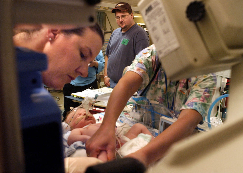 Second Place, Ohio Understanding Award - Bob DeMay / Akron Beacon JournalDana Moore watches a medical personel stabilize his newborn son at Children's Hospital after leaving his wife at Akron General Hospital.