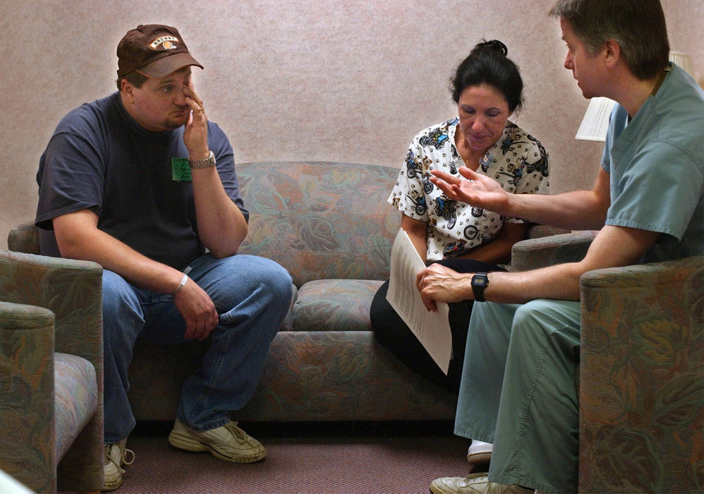 Second Place, Ohio Understanding Award - Bob DeMay / Akron Beacon JournalDana Moore wipes a tear as Dr. Jeffrey Butler explains that his newborn son needs put on ECMO, a heart lung bypass machine.  Ann Kelley, R.N. was there as a witness for the consent forms to be signed. Butler tells Dana to bring his wife over from Akron General Hospital where she delivered hours earlier. As they sign the consent forms Cathy and Dana decide to name their baby Ethan Carney Moore.