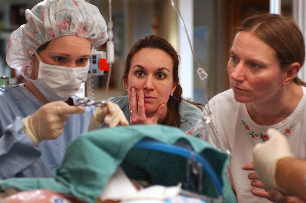 Second Place, Ohio Understanding Award - Bob DeMay / Akron Beacon JournalPerfusionist Melanie Schmidt clamps off tubes attaching Ethan to the ECMO machine as respiratory therapist Michelle Gessler and ECMO coordinator JoAnn Lindeman watch closely. Now it's up to Ethan's heart to circulate his blood and up to his lungs to take over breathing with some help from a ventilator. Hours earlier doctors didn't think this step would be possible.