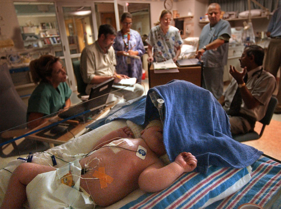 Second Place, Ohio Understanding Award - Bob DeMay / Akron Beacon JournalA towel drapes Ethan's isolet to keep him from being over stimulated while the medical staff talks about the surgery to repair his diaphragmatic hernia  which will take place the following day, 18 days after birth.