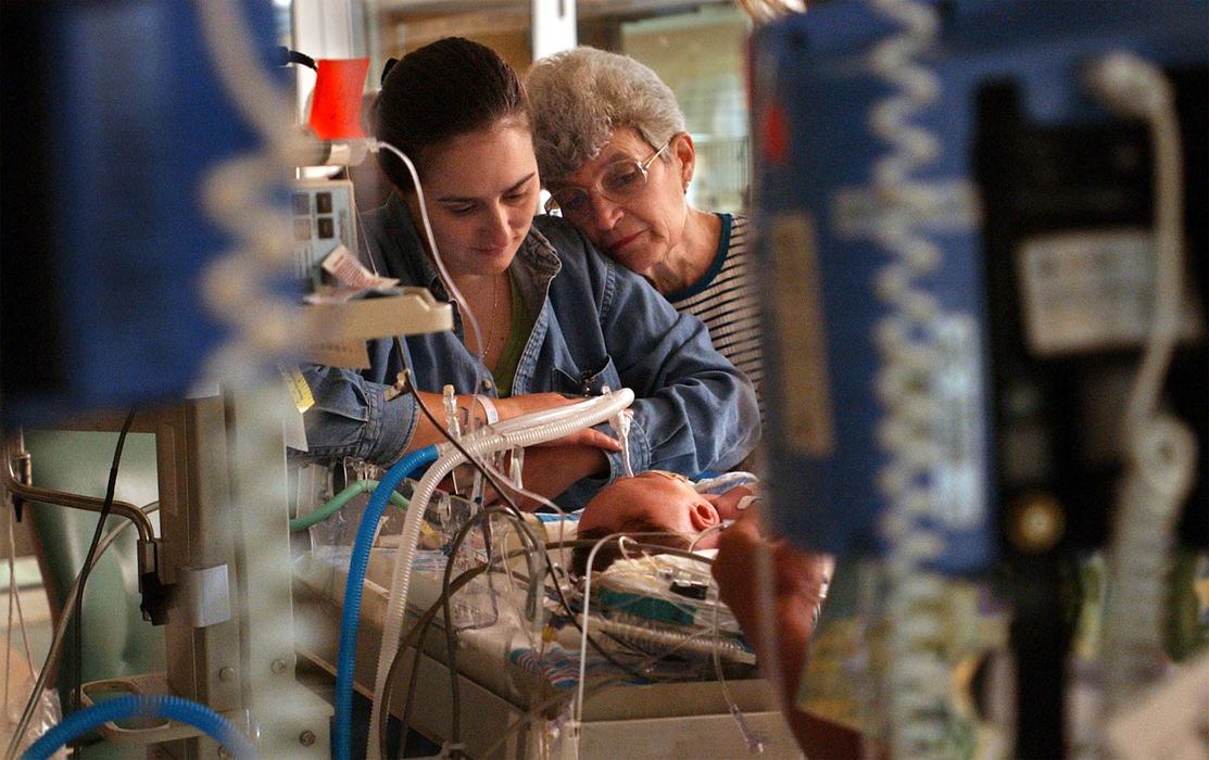 Second Place, Ohio Understanding Award - Bob DeMay / Akron Beacon JournalCathy is comforted by her mother-in-law Patricia Moore in the early morning hours prior to his surgery to repair his diaphragmatic hernia scheduled for noon. Ethan is still not stable enough to move so the surgical team will come to him and perform the operation in his NICU room.