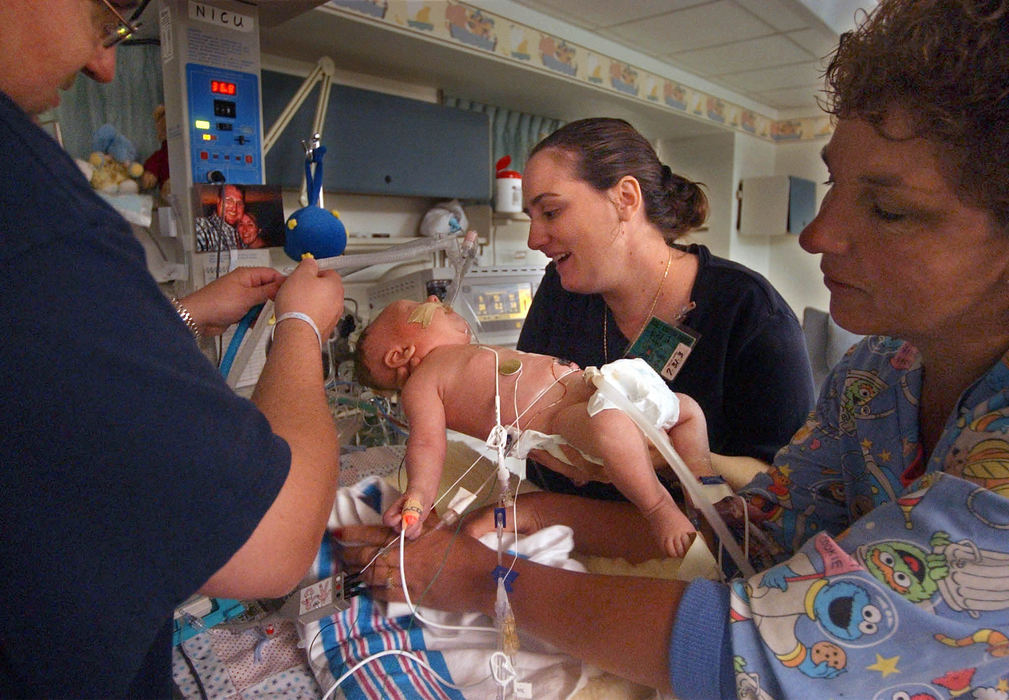 Second Place, Ohio Understanding Award - Bob DeMay / Akron Beacon JournalThe day after surgery to repair the baby's diaphragm, Cathy gets to hold her son for only the second time since he was born. It's only for a moment while registered nurse Lori Lewis changes Ethan's bedding.