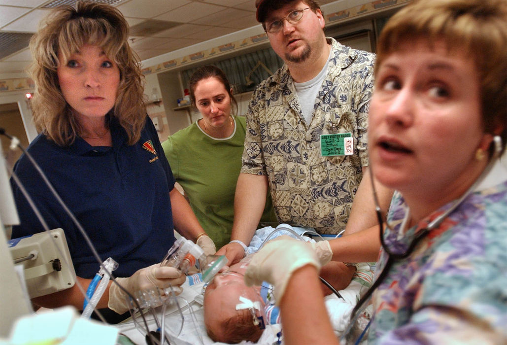 Second Place, Ohio Understanding Award - Bob DeMay / Akron Beacon JournalRespiratory therapist Chris Burnworth, left, Dana and Diane Parrino, R.N. watch the monitors while Cathy keeps her eye on Ethan as he is removed from the ventilator. 