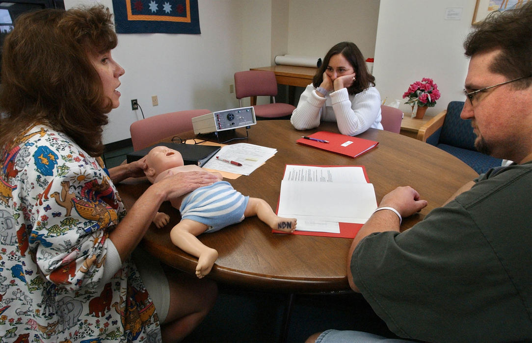 Second Place, Ohio Understanding Award - Bob DeMay / Akron Beacon JournalCathy and Dana hear the words they have been longing to hear: Ethan can go home in five days. Carla Deiss, R.N., left, gives the Moores CPR trainning instructions on how to use oxygen and monitors that Ethan will continue to need at home.