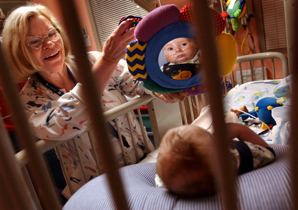 Second Place, Ohio Understanding Award - Bob DeMay / Akron Beacon JournalCheryl Laws, R.N. plays with Ethan in his crib at Akron Children's Hospital.