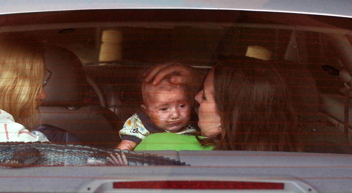 Second Place, Ohio Understanding Award - Bob DeMay / Akron Beacon JournalNurse Cheryl Laws and Cathy calm down Ethan after he got fussy after being strapped in his car seat for the ride home.