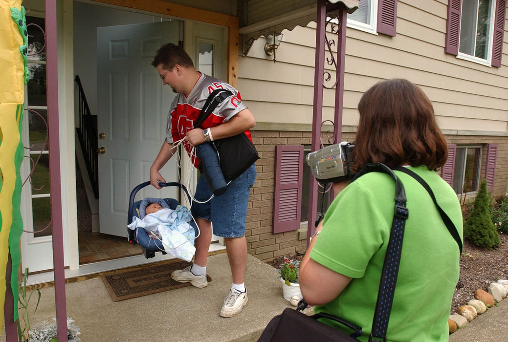 Second Place, Ohio Understanding Award - Bob DeMay / Akron Beacon JournalLike any other parents the Moores' capture the big moment on video as Dana takes Ethan into their home for the first time.