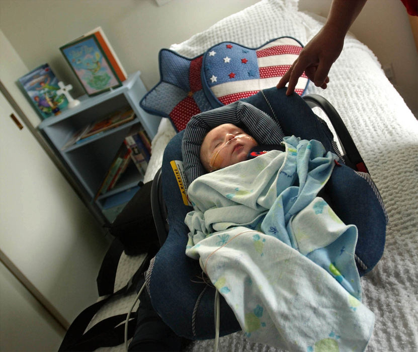 Second Place, Ohio Understanding Award - Bob DeMay / Akron Beacon JournalSeventy nine days after birth Ethan is safe and sound in his bedroom at home. For the first time Ethan is their baby and their baby alone. No one else tends to his needs or answers his cries. Cathy rarely leaves his side, she sleeps in this bed moved into the nursery to care for him. Alarms will sound sound if he stops breathing or if there's not enough oxygen in his body. Any illness or worsening of his breathing problems can kill him.