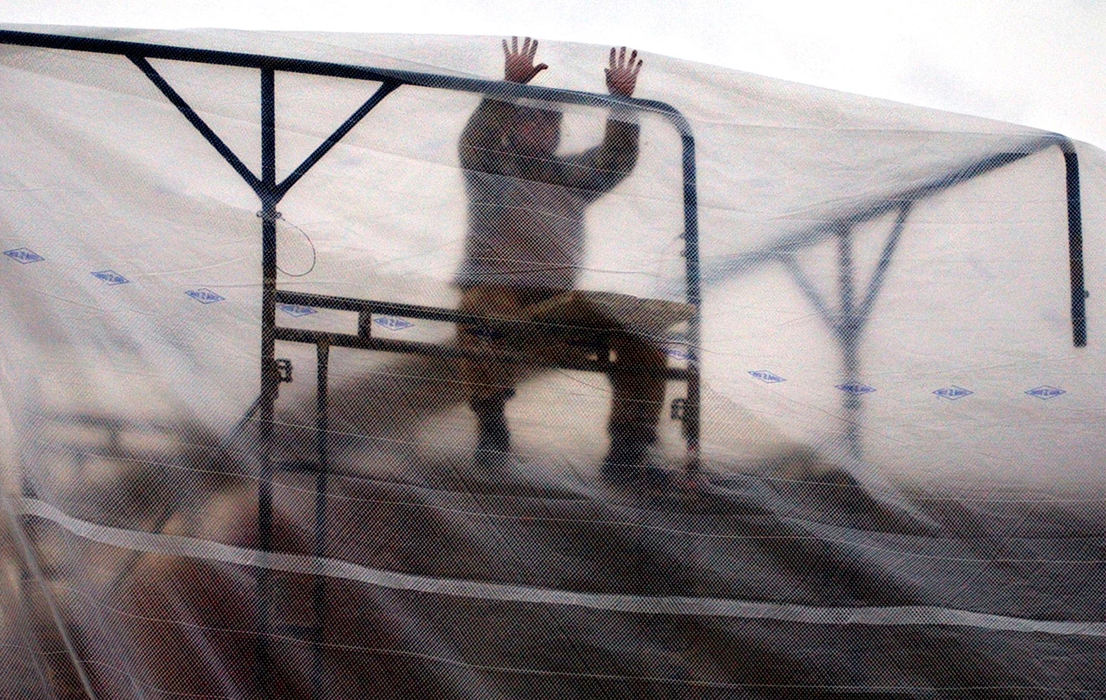 Award of Excellence, Pictorial - Bill Lackey / Springfield News-SunA construction worker at the new Warder Park Elementary construction site puts a giant plastic tarp over the scaffolding he and his co-workers were working on Wednesday. The plastic keeps cold wind out and keeps the heat in so the construction doesn't have to stop due to the extremely cold weather. 