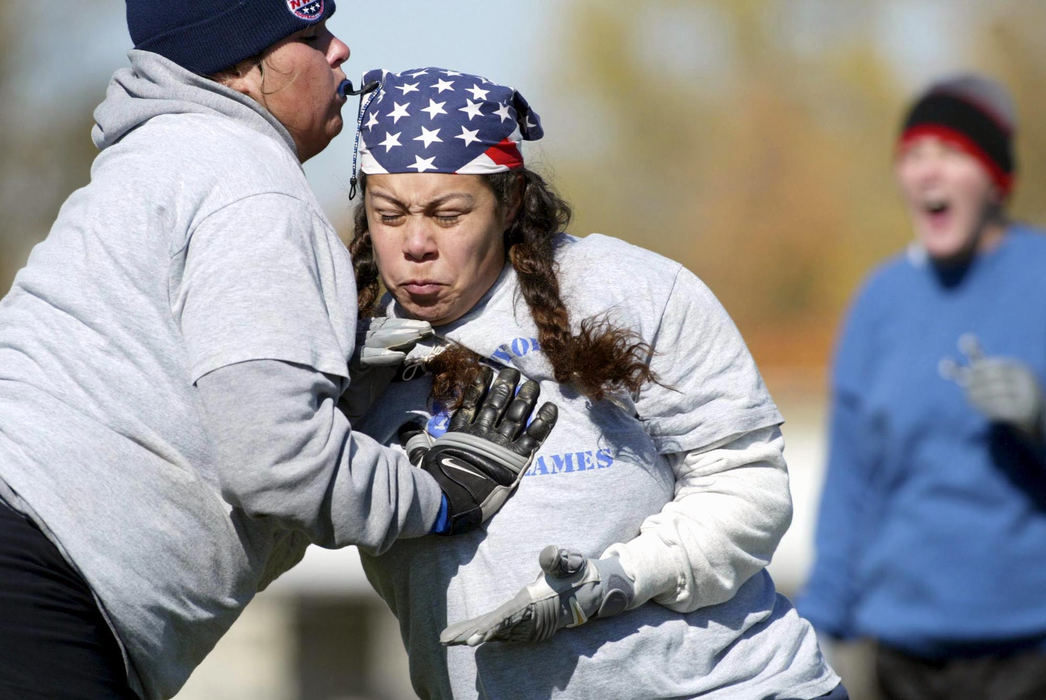 Third Place, Photographer of the Year - Fred Squillante / The Columbus DispatchCentral Ohio's newest professional sports team, The Columbus Flames, are determined to prove they're more than a novelty act. They want to be viewed primarily as a football team. That they are women should be of secondary relevance. The Flames are an expansion team in the National Women's Football Association. Esmeralda Taylor tries to get by Tiff Wheeler (left) during practice. Players had not yet received pads and helmets and practiced without them. 