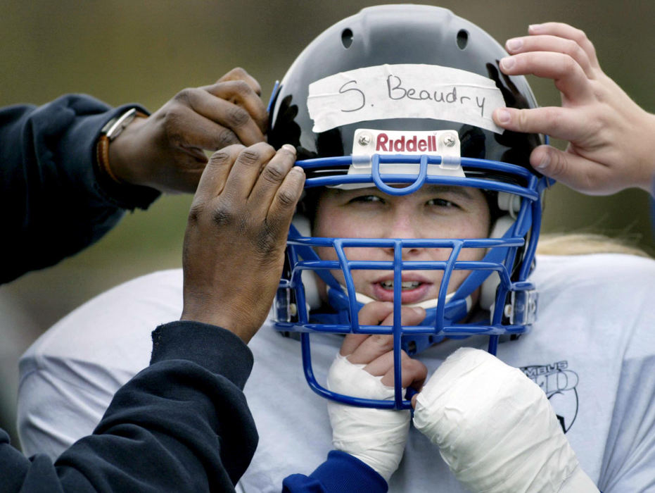 Third Place, Photographer of the Year - Fred Squillante / The Columbus DispatchShannon Beaudry gets suited up at practice in preparation for the Columbus Flames' inaugural game in the National Women's Football Association.