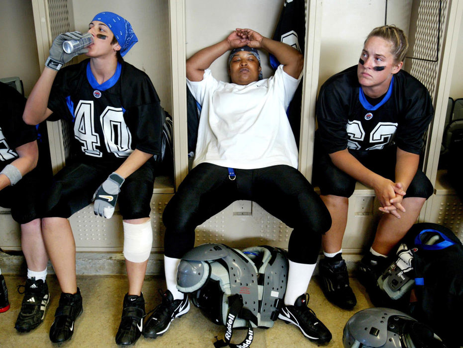 Third Place, Photographer of the Year - Fred Squillante / The Columbus Dispatch From left: Tanya Vanhoose, Sha'ronda Foster, and Sheila Wood, wait inside the locker room before the start of the first-ever game for their team.