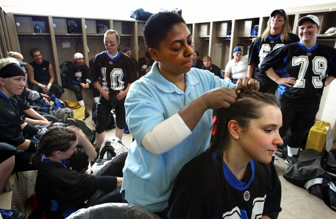 Third Place, Photographer of the Year - Fred Squillante / The Columbus DispatchColumbus Flames fullback Jocelyn Robinson braids the hair of teammate Susan Nelson before the start of the Flames' first-ever game against the Pittsburgh Passion.  Players had their hair braided to keep it out of the way.  Robinson later put her uniform on.