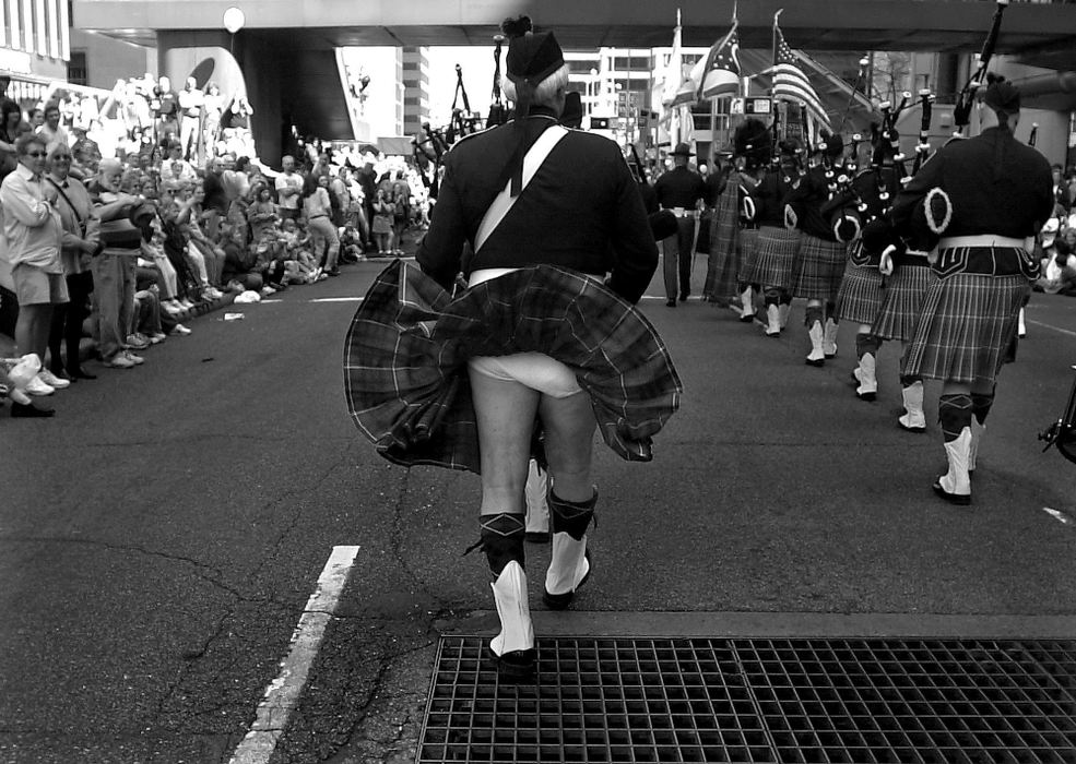 Award of Excellence, Photographer of the Year - Michael E. Keating / Cincinnati EnquirerAir from a street grate provides a glimpse under the kilt of a bagpiper marching in the annual St. Patrick's Day parade. It also provides an amended answer to that old question, "What do they wear under there?".