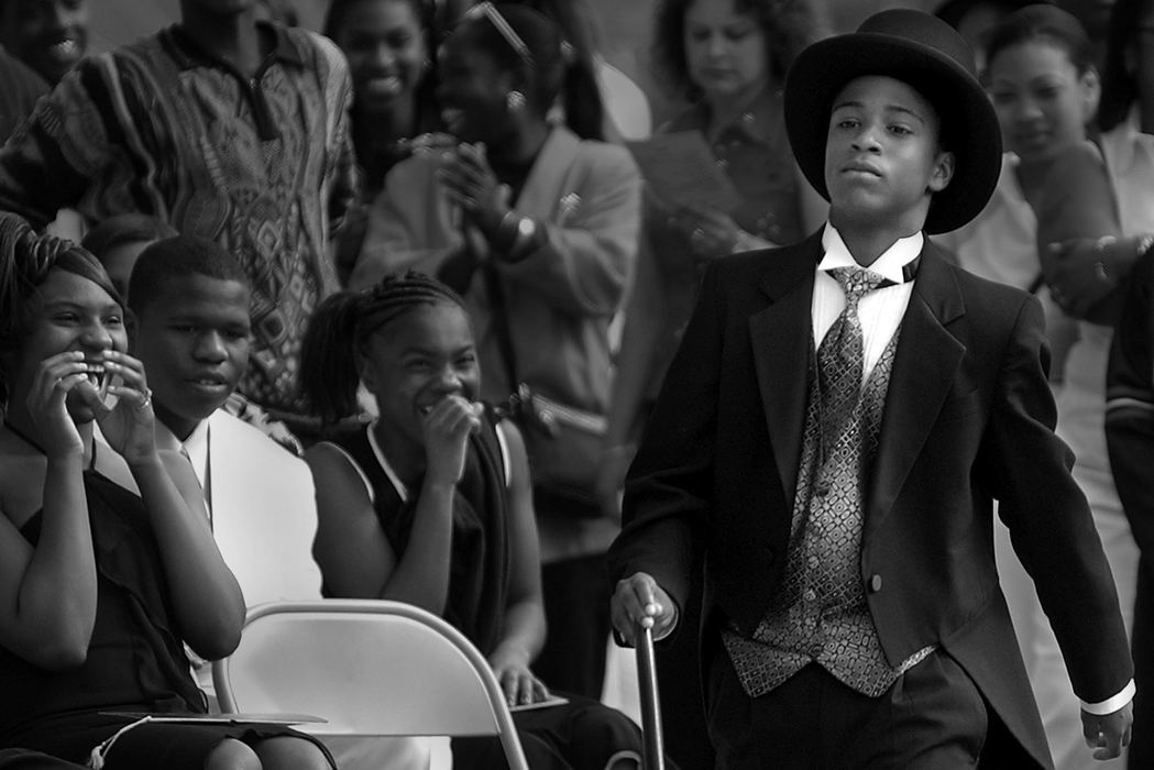 Award of Excellence, Photographer of the Year - Michael E. Keating / Cincinnati EnquirerDionta Thompson pulled out all of the stops donning a top hat and tails for his promotion ceremony at Bloom Middle School. The promotion ceremony was held outside the school to accommodate family and friends who obviously enjoyed his wardrobe.