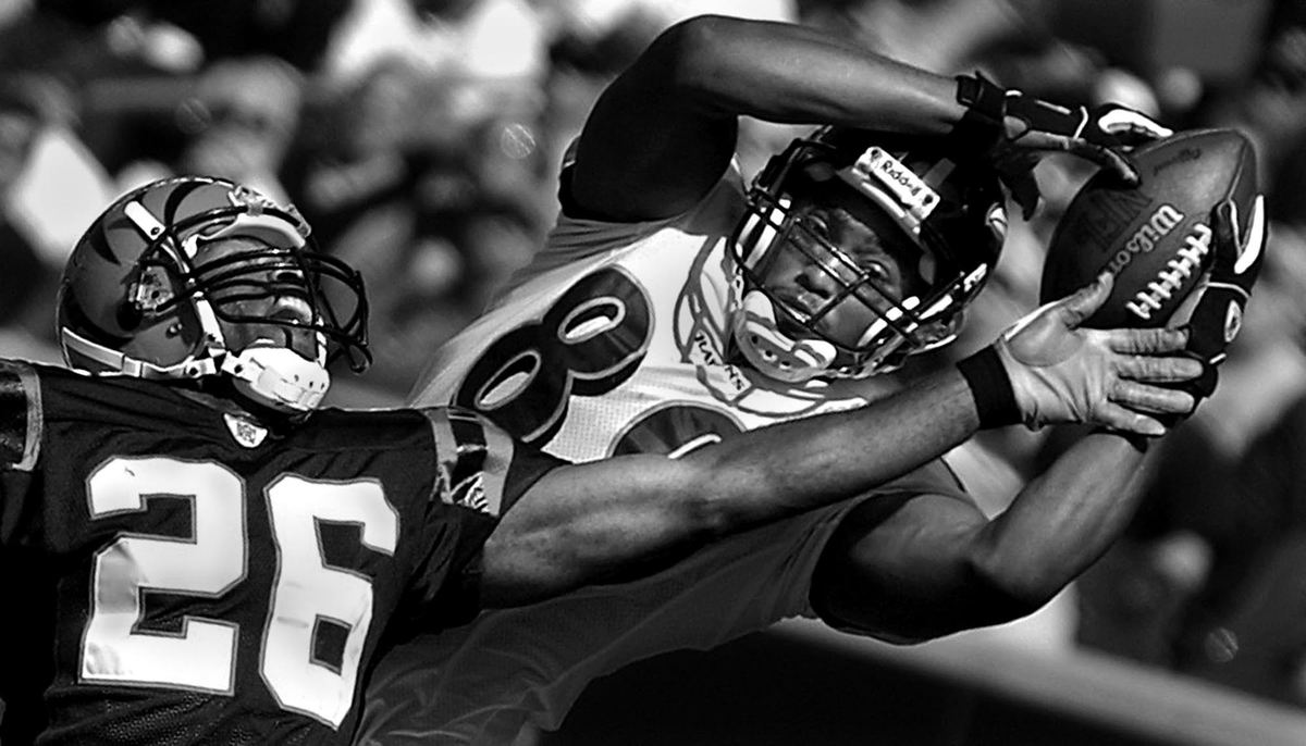 Award of Excellence, Photographer of the Year - Michael E. Keating / Cincinnati EnquirerTravis Taylor reaches out to grab a touchdown pass as Tory James defends.