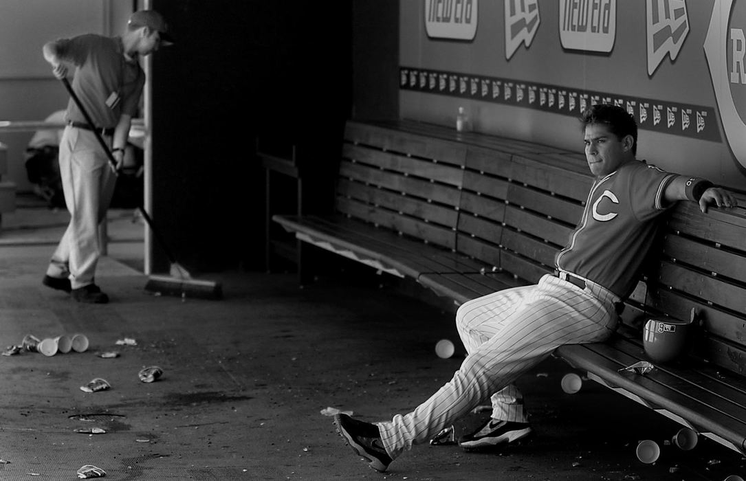 Award of Excellence, Photographer of the Year - Michael E. Keating / Cincinnati EnquirerAs cleanup crews begin to sweep up the trash, Brandon Larson sits in the dugout after going 0-4. He was re-assigned to the minor leagues the next day.