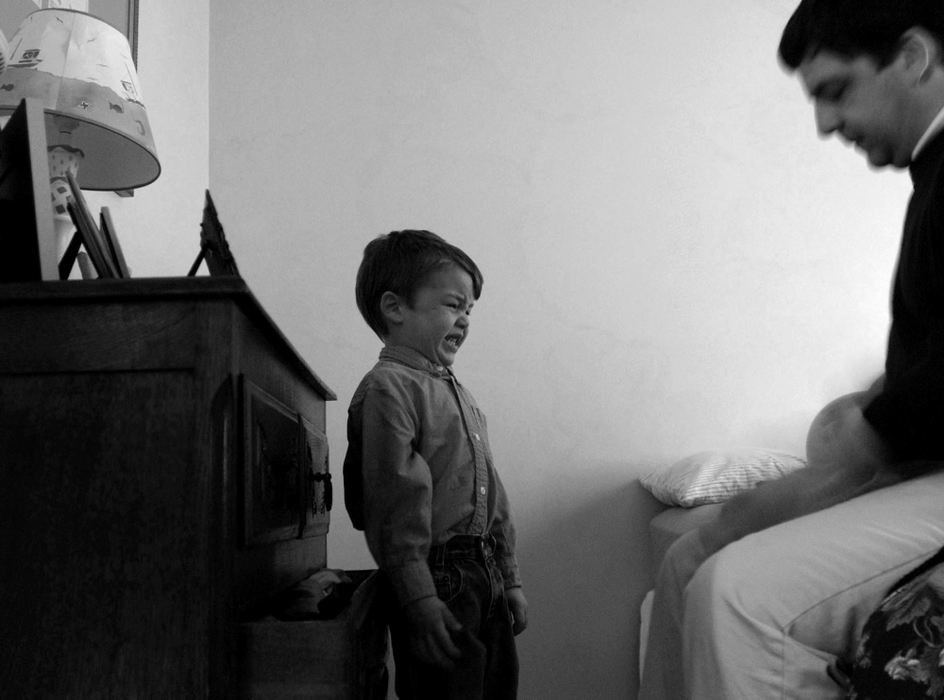 First Place, Photographer of the Year - Dale Omori / The Plain DealerMarc Augier coaches his son Marcel to get dressed in the morning.  Marcel whined in frustration before his father slipped the sweatshirt over his head.  Marc looked Marcel closely in the eye when he was done.  "I'm ready," Marc said, looking for a response.  "I'm ready," Marcel repeated.