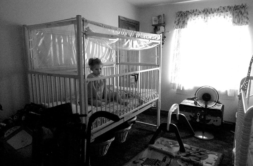 Award of Excellence, Photographer of the Year - Michael E. Keating / Cincinnati EnquirerAudrianna sits alone in her hospital styled bed at home.  She is often found sitting upright because she sleeps poorly.  She is often in a daze and unaware of people in her room.