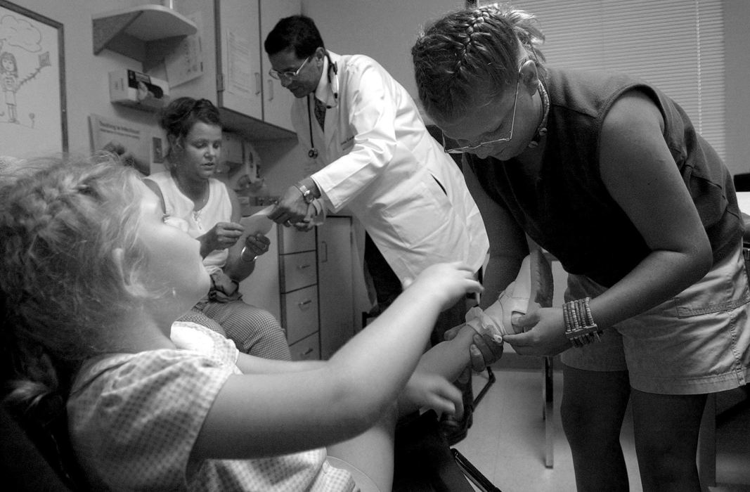 Award of Excellence, Photographer of the Year - Michael E. Keating / Cincinnati EnquirerAmanda cares for her little sister as Melissa Hahn gets prescription and treatment information form a doctor during Audrianna's visit.  Amanda lends a hand and relishes the role of caregiver.