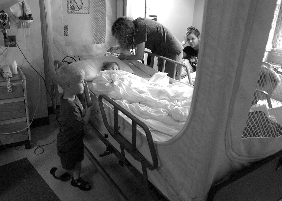 Award of Excellence, Photographer of the Year - Michael E. Keating / Cincinnati EnquirerNoah stands bedside as his mother Melissa looks on quietly while a nurse attends to Audrianna. Hospitalized because of an infection, Audrianna lay unconscious for two days. Melissa had to take Noah to the hospital with her because her husband works nights and she has no place to leave him.