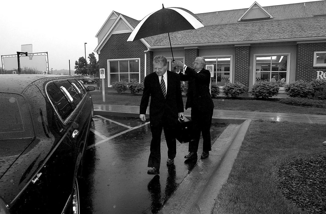 Award of Excellence, Photographer of the Year - Michael E. Keating / Cincinnati EnquirerSpringer is escorted to a limo by an umbrella carrying driver. The limo is a step up from the economy hotel and Springer joked about being the voice of the common man while riding in a limo.