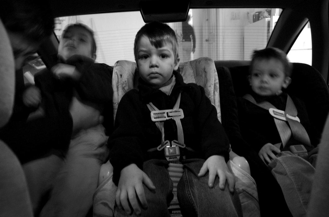 First Place, Photographer of the Year - Dale Omori / The Plain DealerMark Augier seats Henri, left, after Henri ran off instead of climbing into his mother's station wagon with brothers Marcel, middle, and Chritophe. 