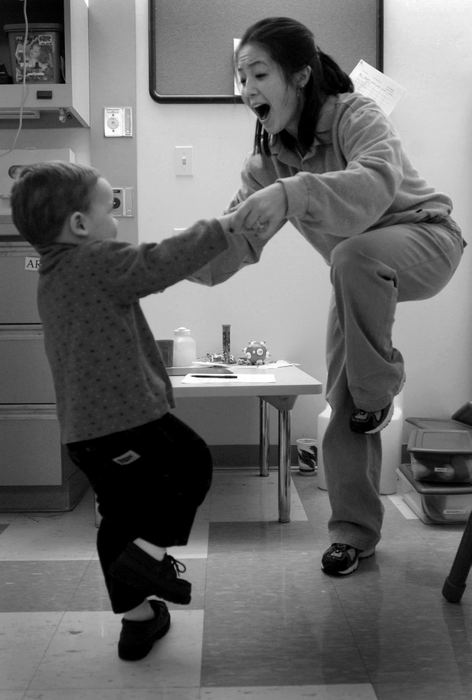 First Place, Photographer of the Year - Dale Omori / The Plain DealerJennifer Maenaka, a therapist at the autism center, attempts to prompt Christophe to imitate her.  Imitation comes naturally for typical children, but not autistic children. 