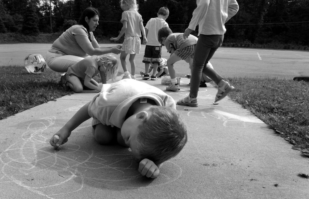 First Place, Photographer of the Year - Dale Omori / The Plain DealerMarcel draws on the sidewalk with chalk on his first day at Bainbridge Christian Preschool at Lord of Life Lutheran Church on his first day of regular preschool.  He didn't interact with the other children.