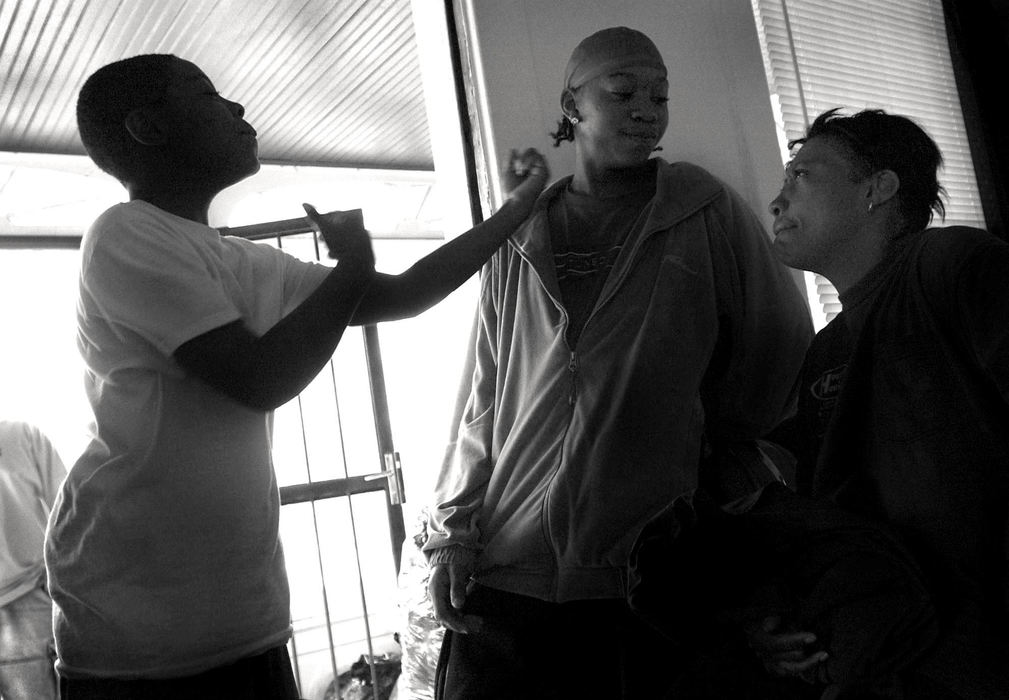 First Place, Photographer of the Year - Dale Omori / The Plain DealerRobert taunts his older brother, Rayon, 13, as the family gets ready to move from their single family house.  Rayon is Noble's calmer, more patient son. She sometimes fears that he is ignored while she deals with bills and Robert's troubles.