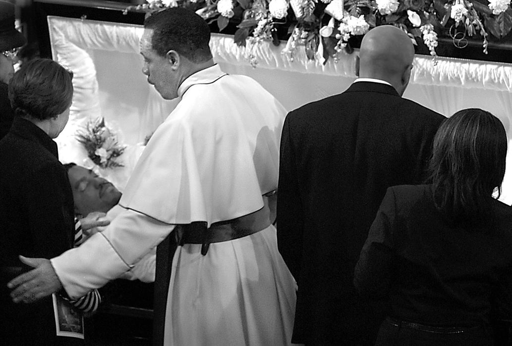 Second Place, Photographer of the Year - Greg Ruffing / FreelanceBishop Norman Wagner (center, in white) and Rita Wagner (to his left), the surrogate parents of Norman Wallace, pay their final respects to Wallace during a memorial service at Mount Calvary Pentecostal Church in Youngstown. Wallace was shot and killed by gunman Biswanath Halder during a shooting rampage at Case Western Reserve University in May.