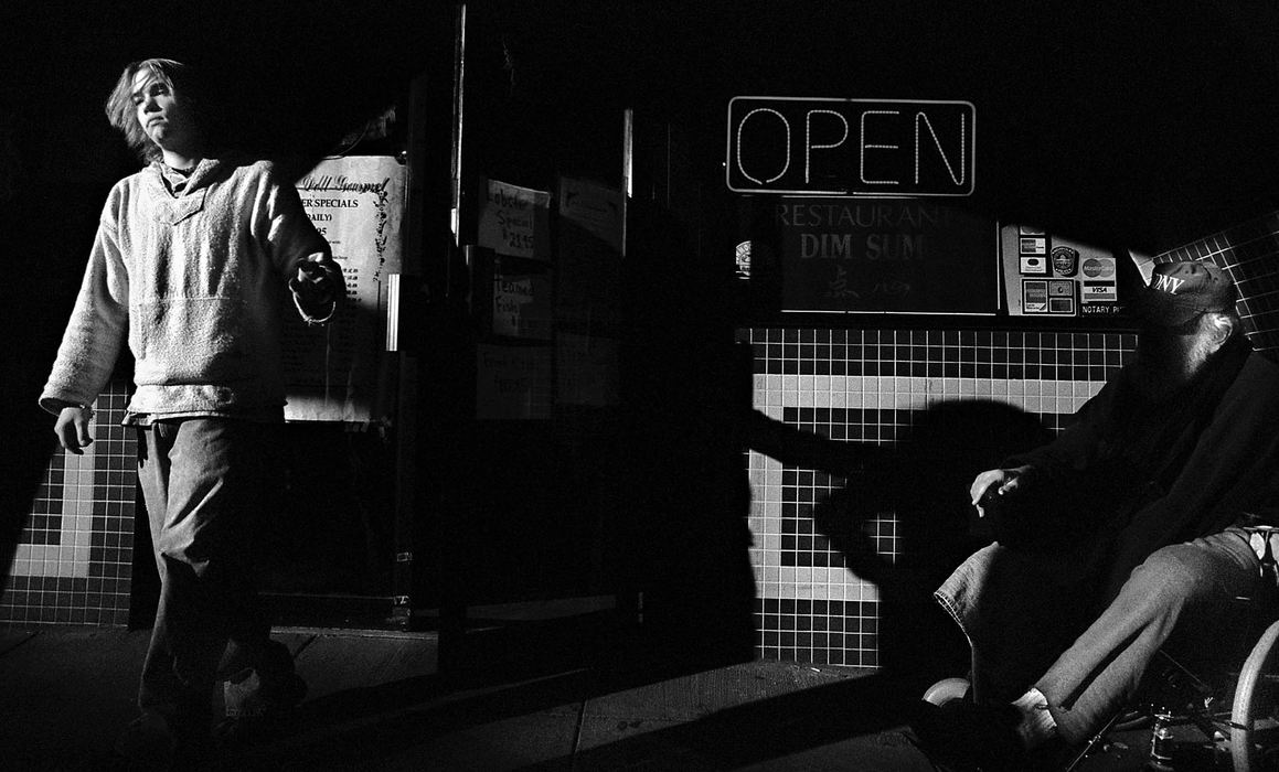 Second Place, Photographer of the Year - Greg Ruffing / FreelanceA restaurant patron brushes past a beggar on the streets of Chinatown in Washington, D.C.