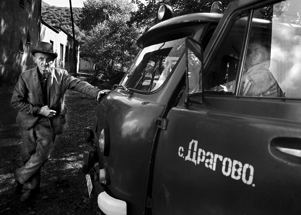 Second Place, Photographer of the Year - Greg Ruffing / FreelanceTwo maintenance workers take a break while repairing a broken ambulance outside a small hospital in Drahovo, Ukraine, at the base of the Carpathian Mountains.