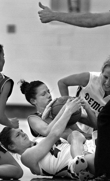 Second Place, Photographer of the Year - Greg Ruffing / FreelanceA jump ball is declared (signified by the referee's hand at top) as Westlake's Amy Banks (white jersey, bottom) and Amherst's Ryan Templeton (dark jersey, center) fight for a loose ball during the second quarter of their game at Westlake High School. Also in on the play are Amherst's Jenny Myers (partially seen at left) and Westlake's Kelsey Slater (partially seen at right).