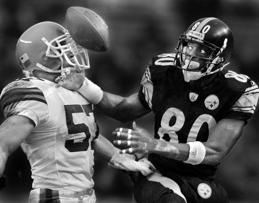 Second Place, Photographer of the Year - Greg Ruffing / FreelancePittsburgh Steelers wide receiver Plaxico Burress tries to catch a pass as it bounces off the helmet of Cleveland Browns defender Dwayne Rudd during the Steelers' 36-33 playoff victory.