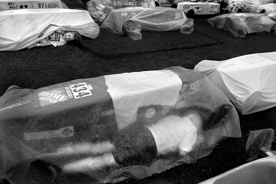 Second Place, Photographer of the Year - Greg Ruffing / FreelanceSean Atkins (foreground) of Waynesboro, Va., and Ashley Wilt of Akron scramble for cover with their cars as a brief rain storm interrupted the running of the All-American Soap Box Derby.