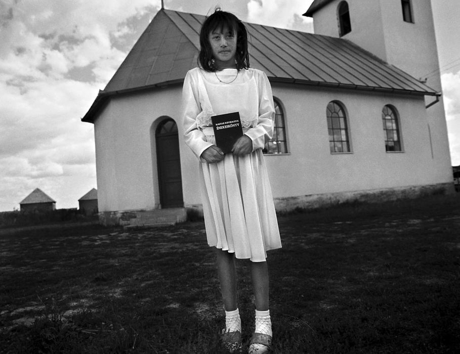 Second Place, Photographer of the Year - Greg Ruffing / FreelanceKetrin Lakatos, age 10, with her Bible outside a Roma church. High rates of illiteracy keep many Roma away from organized religion. Furthermore, religious practices were essentially banned during communist times.